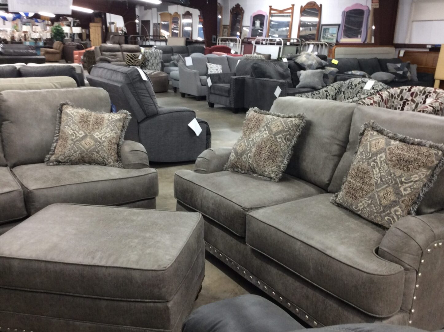 gray couches with throw pillows and other furniture